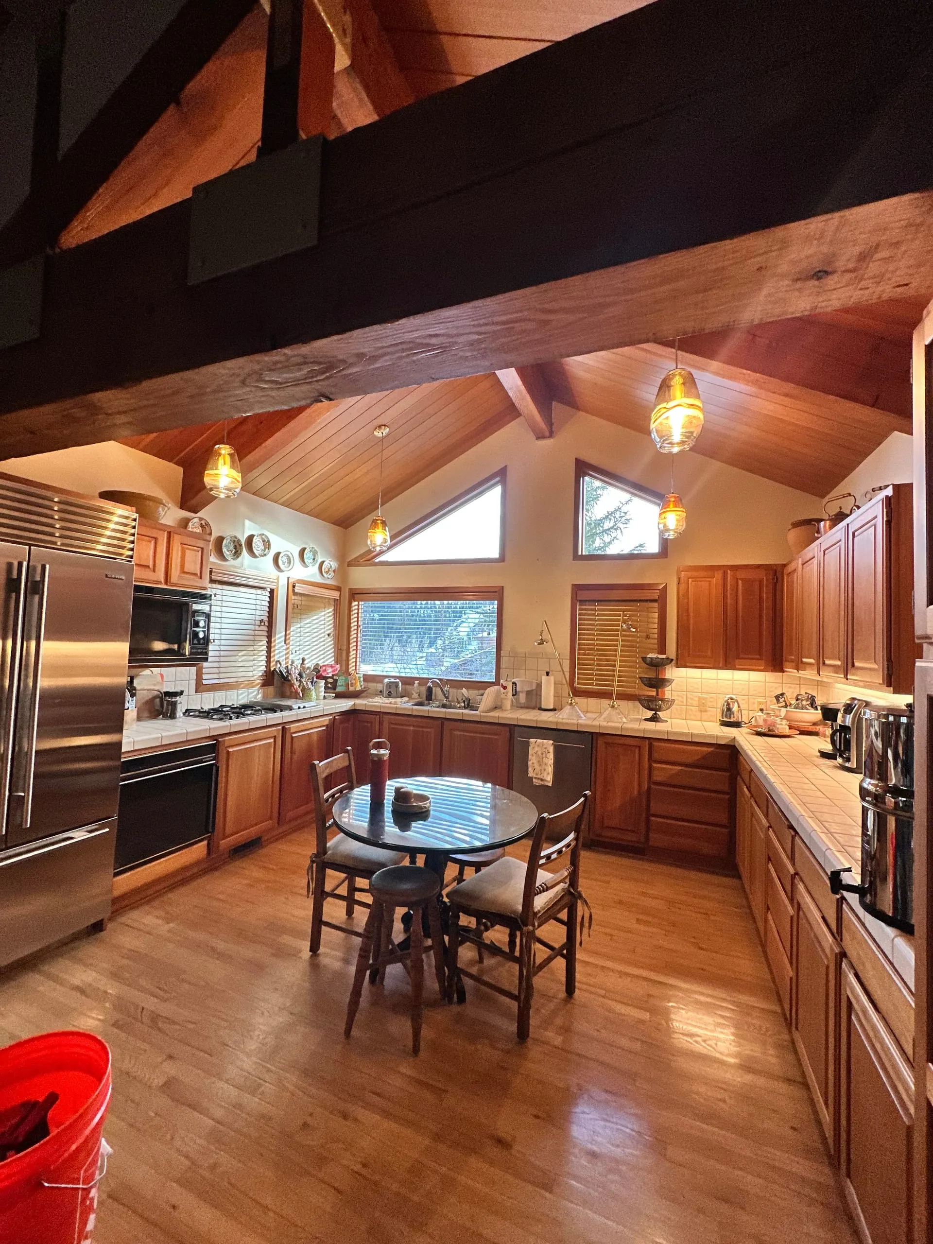 Cabin kitchen pendants vaulted wood