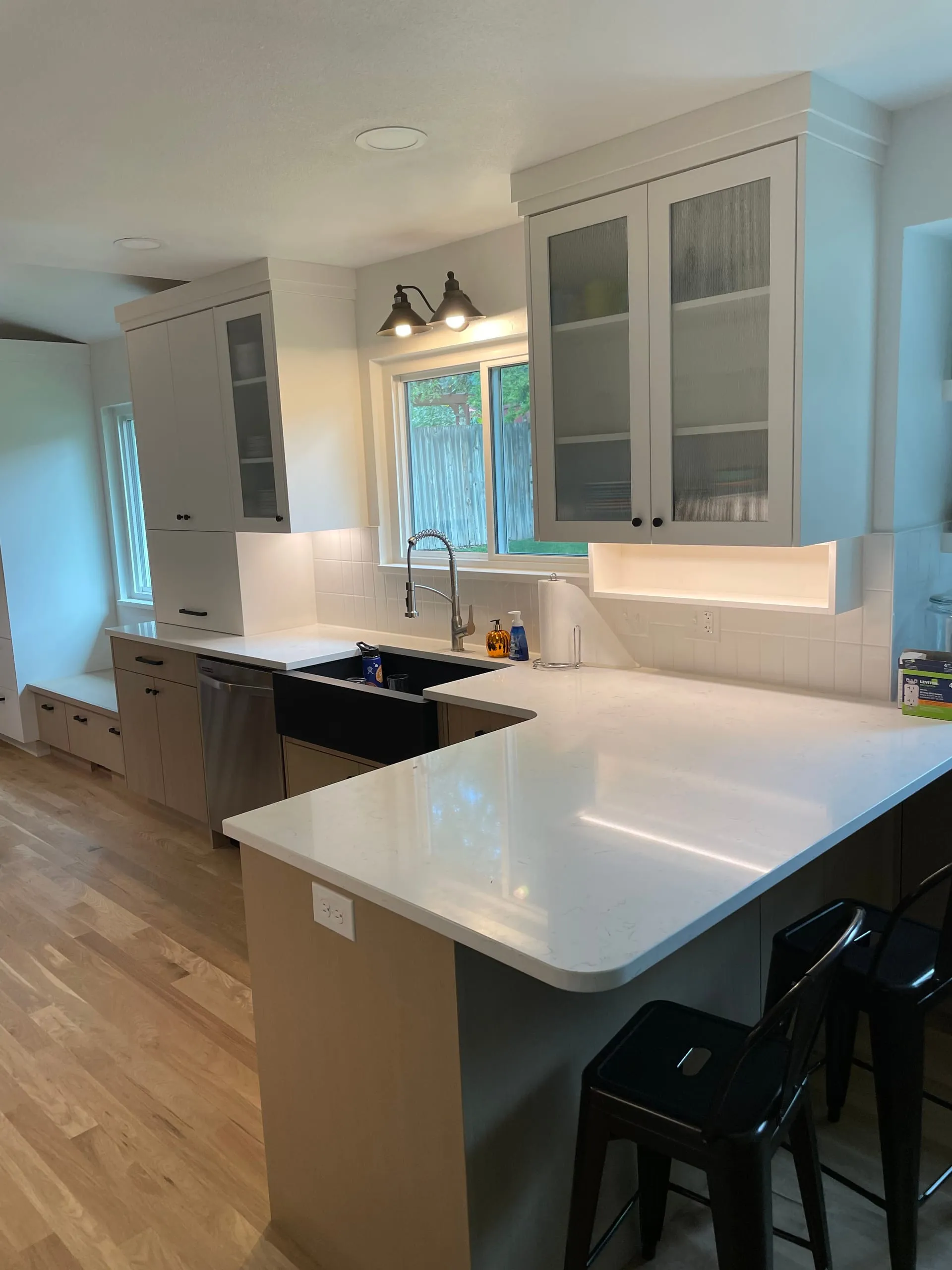 White kitchen peninsula pendants